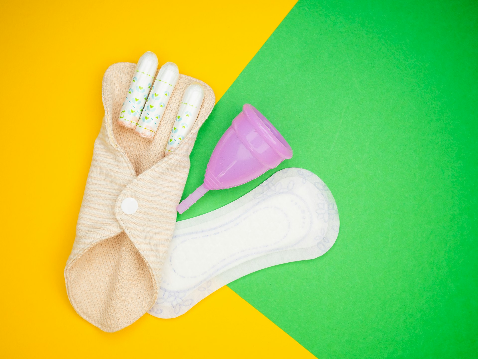 a pair of gloves and a baby bottle on a yellow and green background